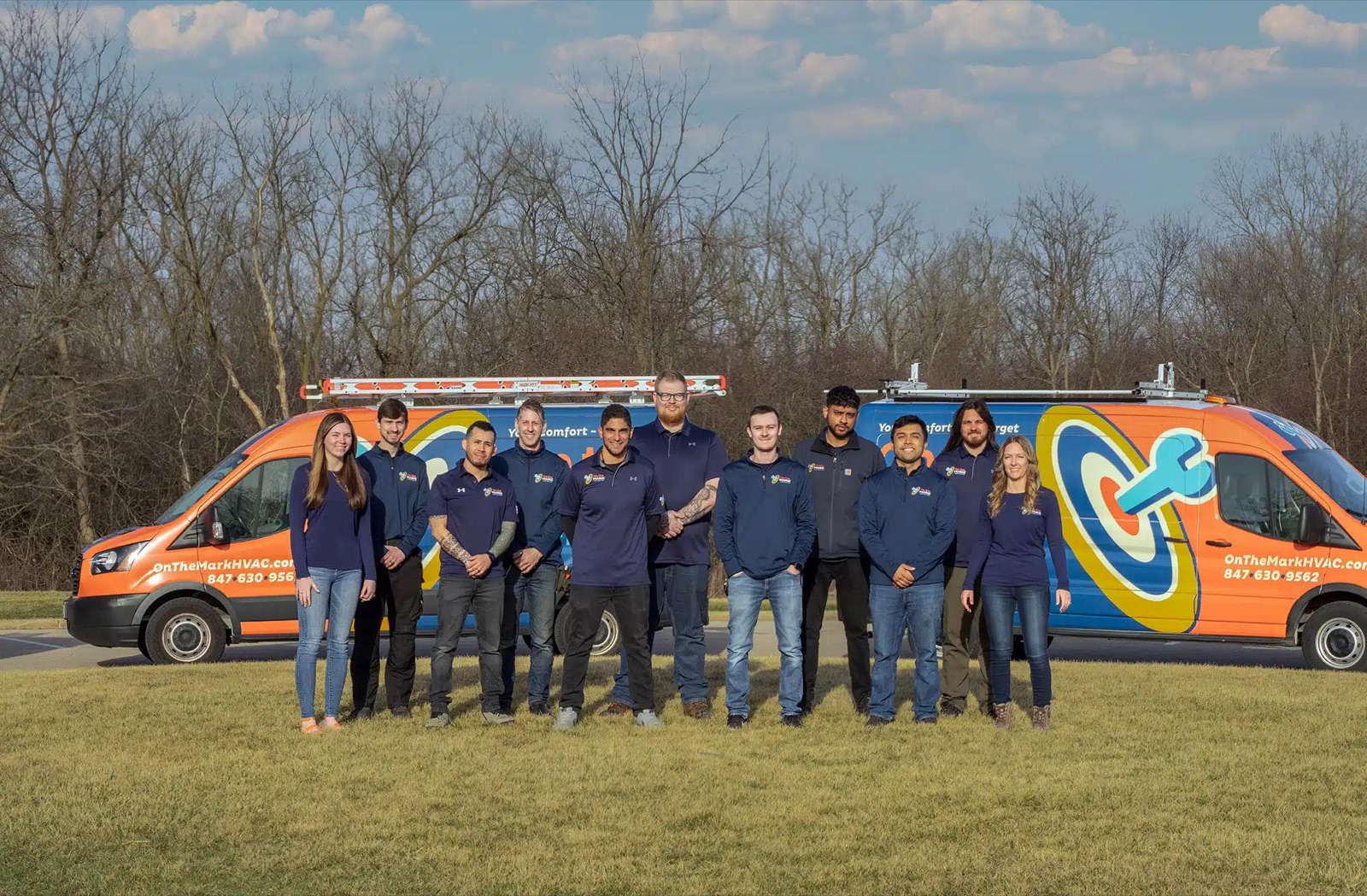 The On the Mark Heating & Air team lined up in front of their service vans