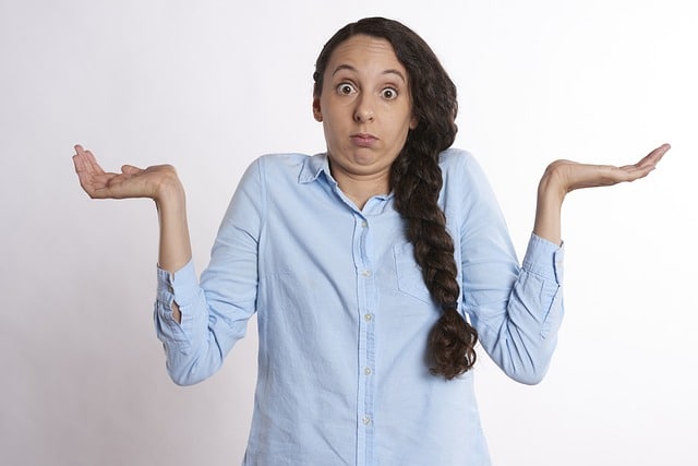 confused woman shrugging with arms up