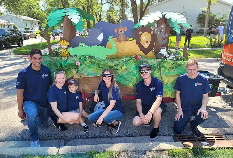 On the Mark team in front of float at Streamwood Summer Celebration